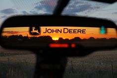 the side view mirror of a vehicle with john deere on it