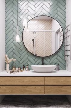 a bathroom with a round mirror above the sink and wooden drawers underneath it, along with other items