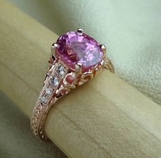 "Antique Style Natural Pink Sapphire with Diamonds Engraved Carved Filigree Engagement Ring 14k Rose Gold We designed and handmade this ring. The center oval pink sapphire measurements are 8.2 mm x 6.4 mm and carat the weight is 2.45 cts. The pink sapphire is absolutely stunning. With 8 VS-SI clarity range side diamonds carat weight .12 Cts. It is made in 14k rose gold. Total weight is 2.56 cts. We can make it any size from 5-7 and you still be able to return it within the listed time frame. Siz Pink Sapphire Ring Engagement, Filigree Engagement Ring, Gold Hand, Gold Hands, Fine Jewels, Antique Rings, High Quality Jewelry, Promise Ring, Antique Style