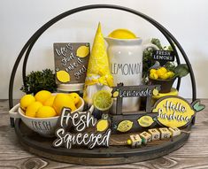 a basket filled with lemons, lemonade and other items on top of a wooden table