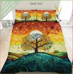 a bed with an artistic painting on the cover and pillow cases in front of it