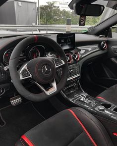 the interior of a mercedes c - class coupe with black leather and red stitching