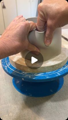 a person is using a device to make something out of clay on top of a table