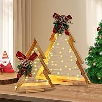 three wooden christmas trees with lights on them