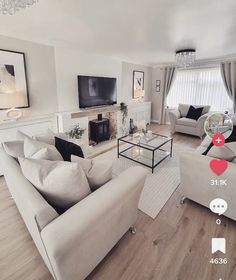 a living room filled with furniture and a flat screen tv on top of a wooden floor