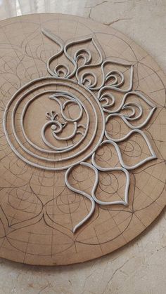 an intricately designed wooden plaque on the floor