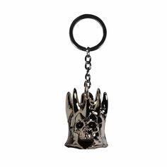 a metal keychain with a skull and crown on it's head is shown