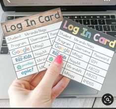 someone holding up two login cards in front of a laptop computer with the text login card on it