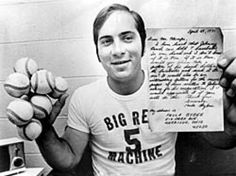 a man holding up some doughnuts in his hands