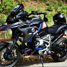 a black motorcycle with red, blue and white stripes parked on the side of the road