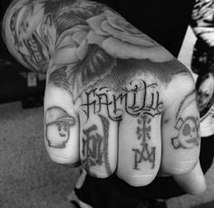 black and white photograph of hand with tattoos on it