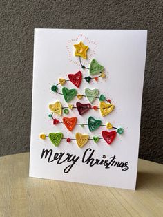 a christmas tree made out of buttons on a card