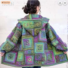 a woman is wearing a colorful crocheted coat