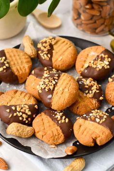 a plate full of cookies with nuts on top