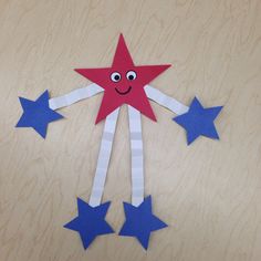 a red, white and blue paper star with eyes