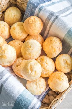 a basket filled with muffins sitting on top of a blue and white towel