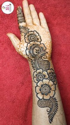 the hand is decorated with henna and flowers