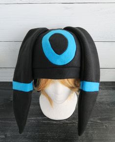 These hats are made from fleece and interfacing in the ears but still have floppiness to them and do not stand up (sorry but I do not offer this option). ⫸ Perfect for: fans, cold weather, costumes, or conventions. Very warm! ⫸ Size: Fits anyone age 5+, one size fits most. Circumference about 24-25 in.⫸ Care instructions: I recommend hand wash but should be fine in machine wash cold.All hats are made in a smoke-free, pet-free environment. All hats are made with a sewing machine. Patterns and des Adjustable Black Hat With Ears, Adjustable Hats For Winter Costume, Adjustable Winter Hats For Costume Events, Adjustable Beanie Hat For Cosplay, Adjustable Beanie For Cosplay, Black Hat For Cosplay, One Size Fits Most, Black Cosplay Hat, One Size Fits Most, Black Cosplay Hat One Size Fits Most, Adjustable Felt Costume Hat For Winter