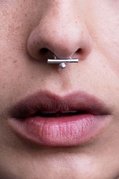 a woman's nose with a piercing on it