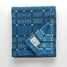 a blue and white blanket with a tag on it