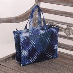 With a tie-dyed pattern created using the shibori technique this pretty blue and white tote will take you anywhere you want to go. Bali's Indira Soerojo designs the small cotton tote with quilted panels on front and back and coordinating straps. The fully-lined interior features one open pocket to keep small items safe and closes with a zipper. Blue Song, Shibori Techniques, Shibori Pattern, Tie Dye Techniques, Quilted Totes, White Tote, Dyeing Process, Cotton Tote Bag, Women Artisans