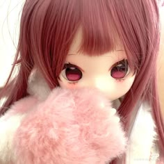 a close up of a doll with pink hair and big eyes holding a teddy bear