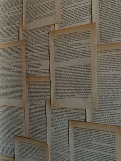 many old books are stacked on top of each other with torn pages attached to them