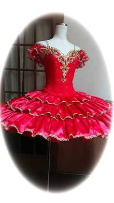 a red ball gown on display in front of a mirror