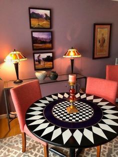 a dining room with purple walls and black and white checkerboard table cloth on it