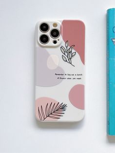 an iphone case with a plant on it next to a book