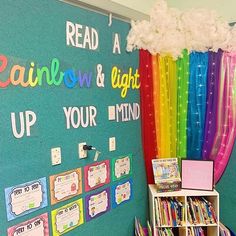 a classroom wall with rainbow and light up books