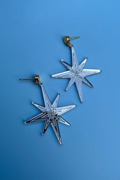 Silver earrings with a unique star shape and a lightweight feel. They are fashionable and are fun for the holidays. From the vendor; We devote great care to crafting every piece, ensuring a high level of attention to detail. Our use of nickel-free metal ensures that each piece is hypoallergenic. While our earrings are designed to be durable, we suggest handling them with care, as they are works of wearable art. Nickel free. Silver Starburst Earrings For Party, Star-shaped Metal Earrings For Party, Silver Star-shaped Earrings, Nickel-free Star Jewelry For Parties, Nickel Free Star Shaped Party Jewelry, Trendy Silver Star Earrings, Nickel-free Metal Star Earrings, Nickel-free Star-shaped Metal Earrings, Star-shaped Nickel-free Plug Earrings For Gift