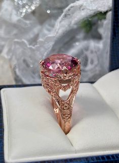 Natural Pink Topaz Ring Princess Design#29 Custom Made Inspired by Georgian and Victorian era filigree designs, I now offer this stunning reproduction in sterling silver with rose gold overlay. This fabulous ring is set with a 7.4ct VVS natural genuine pink topaz gemstone. The round full cut high quality gemstone is 13mm (1/2th of an inch) in diameter. The gemstone has excellent color and clarity. The inside of the band is marked 925 for sterling. Notice the beautiful intricate leaf prongs and f Fine Jewelry Rose Gold Topaz Ring With Accent Stones, Rose Gold Topaz Ring With Accent Stones, Rose Gold Topaz Ring For Gift, Rose Gold Filigree Ring Gift, Elegant Rose Gold Topaz Birthstone Ring, Fine Jewelry Rose Gold Topaz Ring, Rose Gold Topaz Round Jewelry, Rose Gold Round Topaz Jewelry, Rose Gold Round Topaz Birthstone Ring