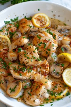 a white bowl filled with shrimp and lemon slices