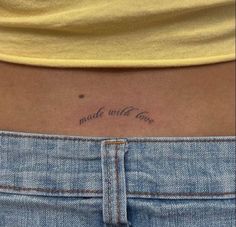 a woman's lower back tattoo with the words made with love written on it