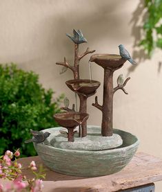 a bird bath with three birds on it