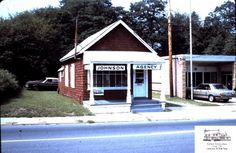 an old photo of a small building on the corner