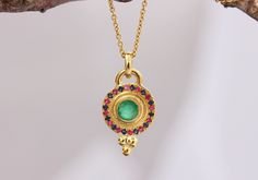 "Amazing boho antique style pendant necklace set with emerald, sapphire, and ruby, in 14k/18k/22k solid yellow, white or rose gold. This gold bohemian necklace is stunning and unique. It has a round gold pendant in ethnic design with 3 gold dots at the bottom. The pendant is set with a central big emerald, which is surrounded by rubies and blue sapphires. This necklace is delicate but has a lot of character and will be the center of attention, with any outfit you'll wear. The necklace's antique- Temple Jewelry Style Emerald Gemstone Necklace As Gift, Emerald Necklace For Gift In Temple Jewelry Style, Emerald Gemstone Necklace For Gift, Temple Jewelry Style, Temple Style Emerald Gemstone Necklace As Gift, Gold Multi-stone Emerald Necklace Gift, Temple Jewelry Style Emerald Pendant Necklace, Traditional Emerald Pendant Necklace, Traditional Yellow Gold Emerald Necklace Gift, Round Gold Pendant