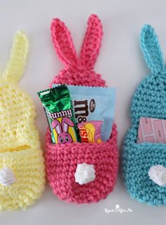 three crocheted bunny bags with candy in them