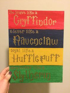 a hand holding up a wooden sign that says, be brave like a gryffindor