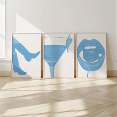 three blue and white paintings on the wall next to each other in an empty room