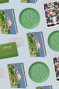 several green plates with designs on them next to cards and envelopes that have been cut out