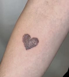 a fingerprint in the shape of a heart on someone's left arm,