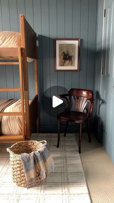 a room with two bunk beds and a chair