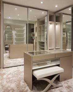 an image of a dressing room with mirrored walls and mirrors on the wall, along with a bench in front of it