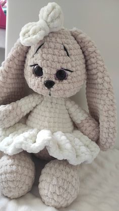 a crocheted stuffed animal sitting on top of a bed