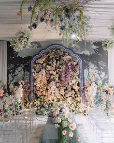 a room filled with lots of flowers and chairs