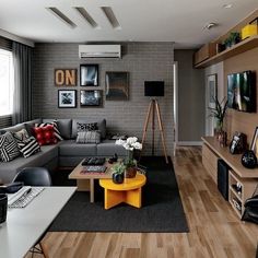 a living room filled with lots of furniture next to a wall mounted air conditioner