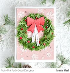 a card with a christmas wreath on it and the words merry pink posh quest designer