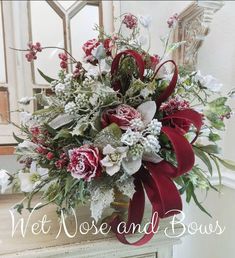 a vase filled with red and white flowers